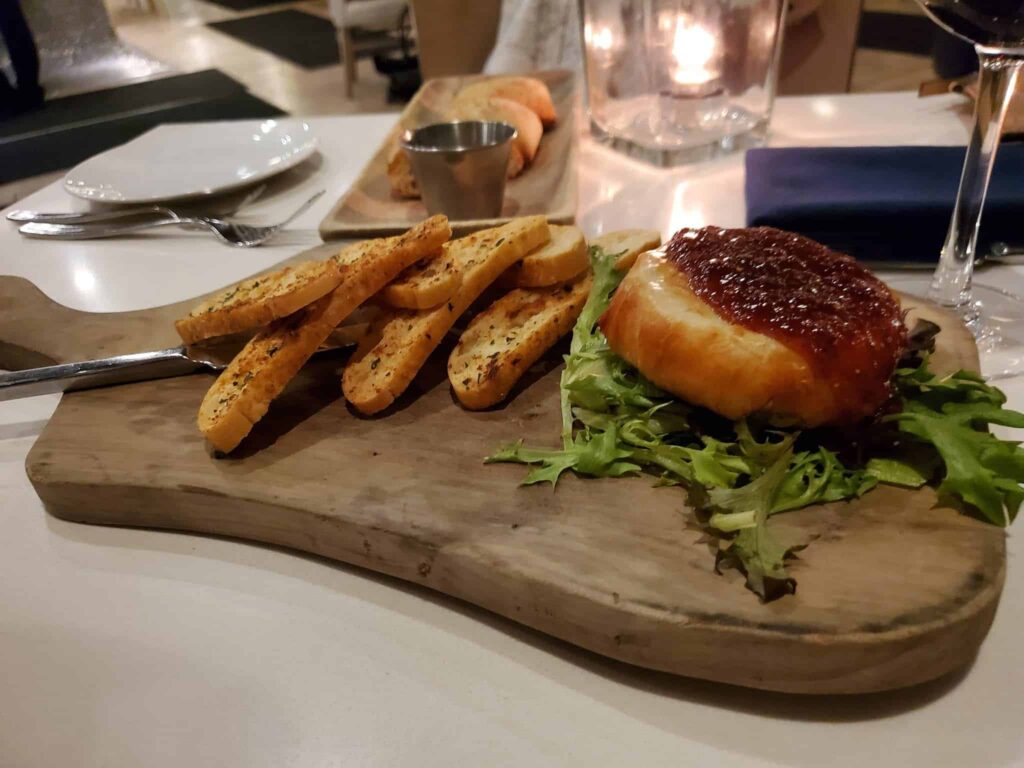 Enjoying bread and brie at the Lakeside Seafood & Grill, an upscale restaurant in Living Water Resort & Spa
