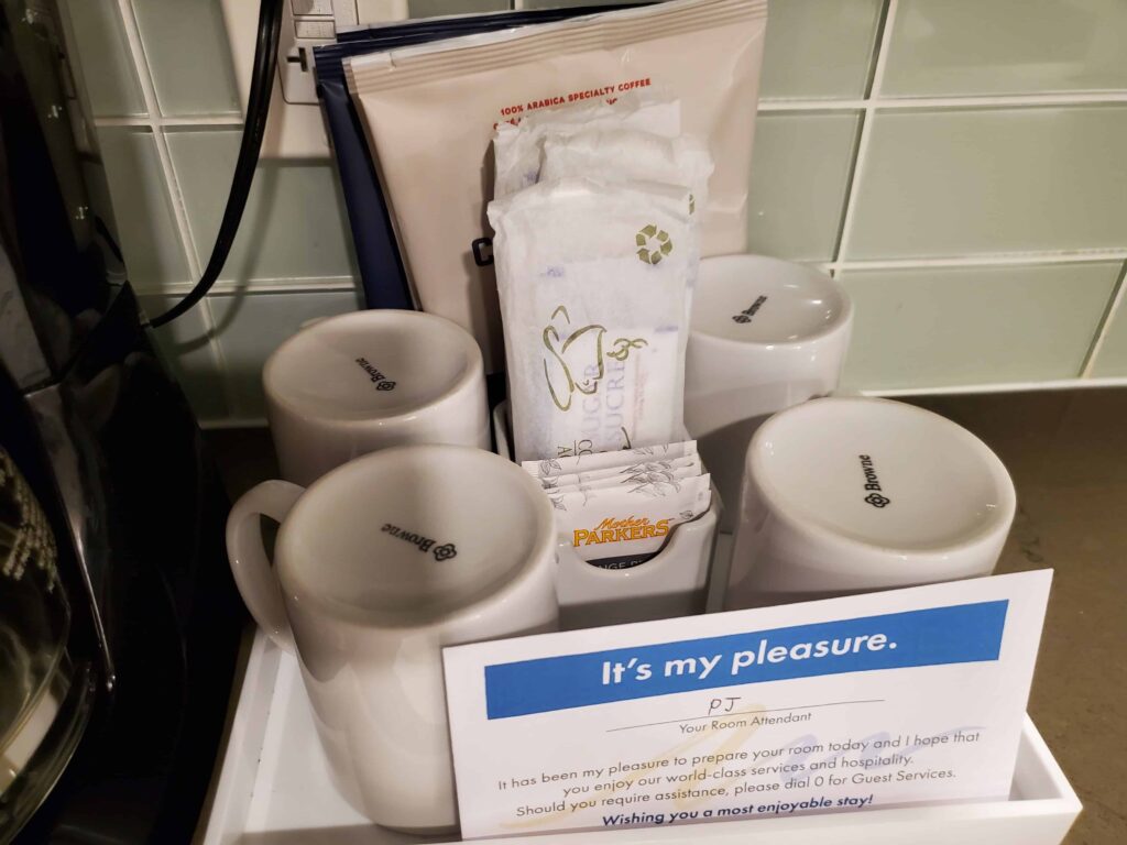 Coffee, tea, sugar, and large coffee maker in the kitchen