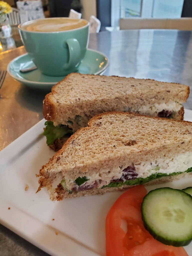 Enjoying a tuna and cranberry sandwich and latte at the Heavenly Cafe, one of Collingwood's best cafes