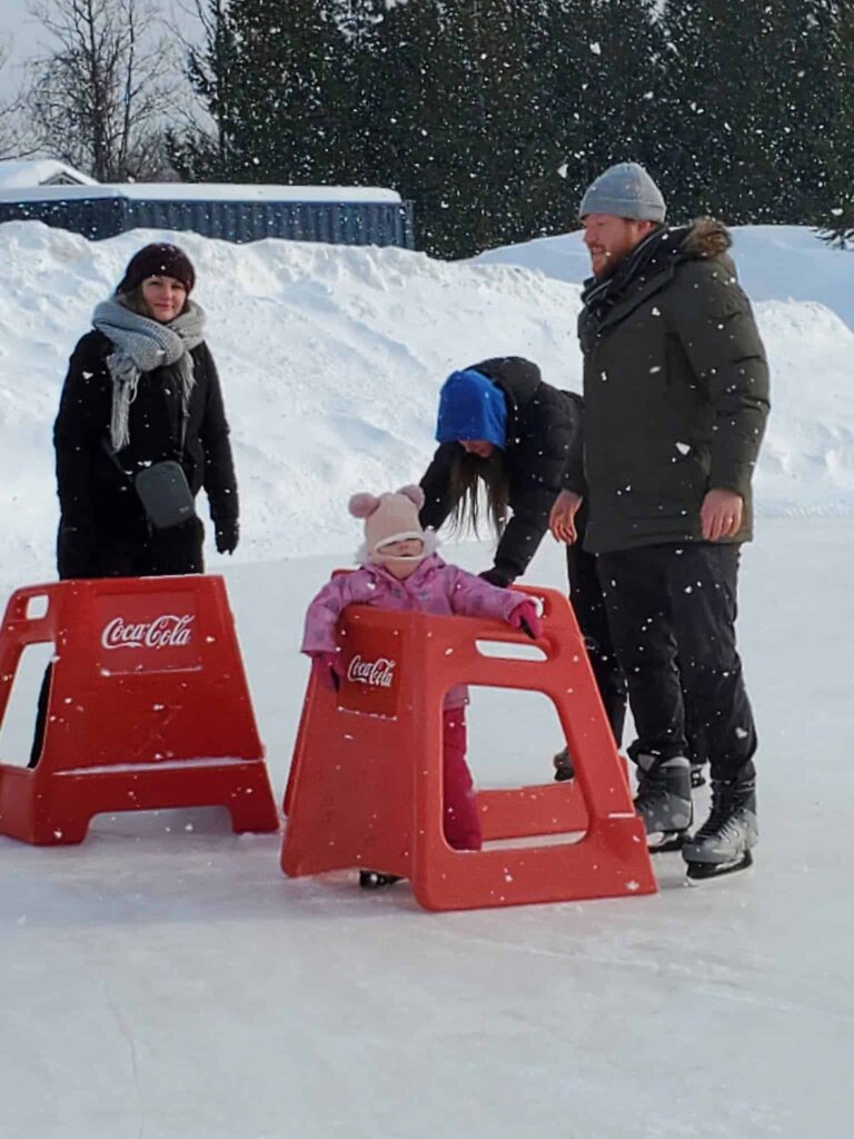 Family fun skating when it's snowing during a winter visit to Blue Mountain