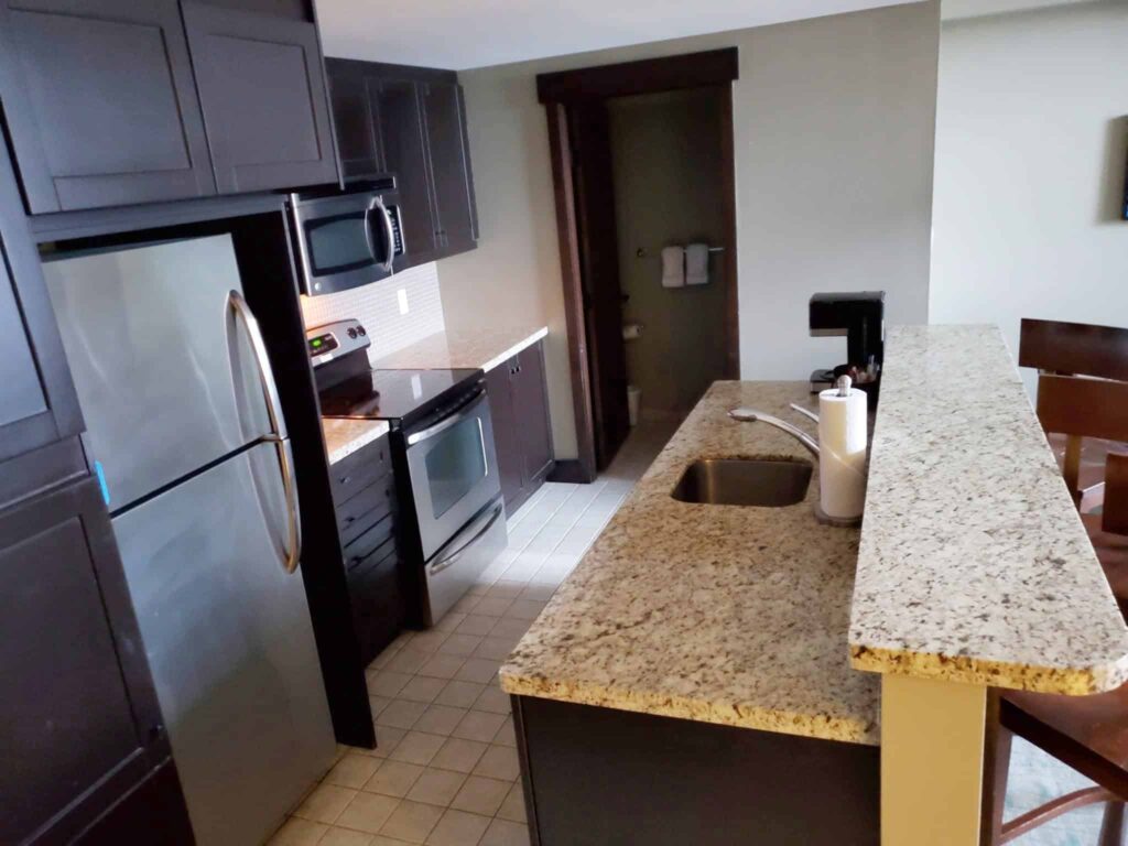 The kitchen in the 2 bedroom suite at Mosaic was open concept with the livingroom and was equipped with fridge, stove, and dishwasher