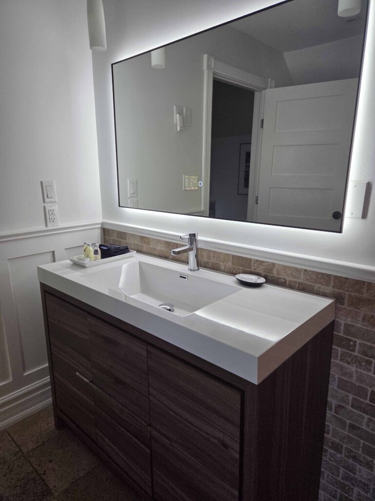 The updated vanity and make-up mirror in the bathroom
