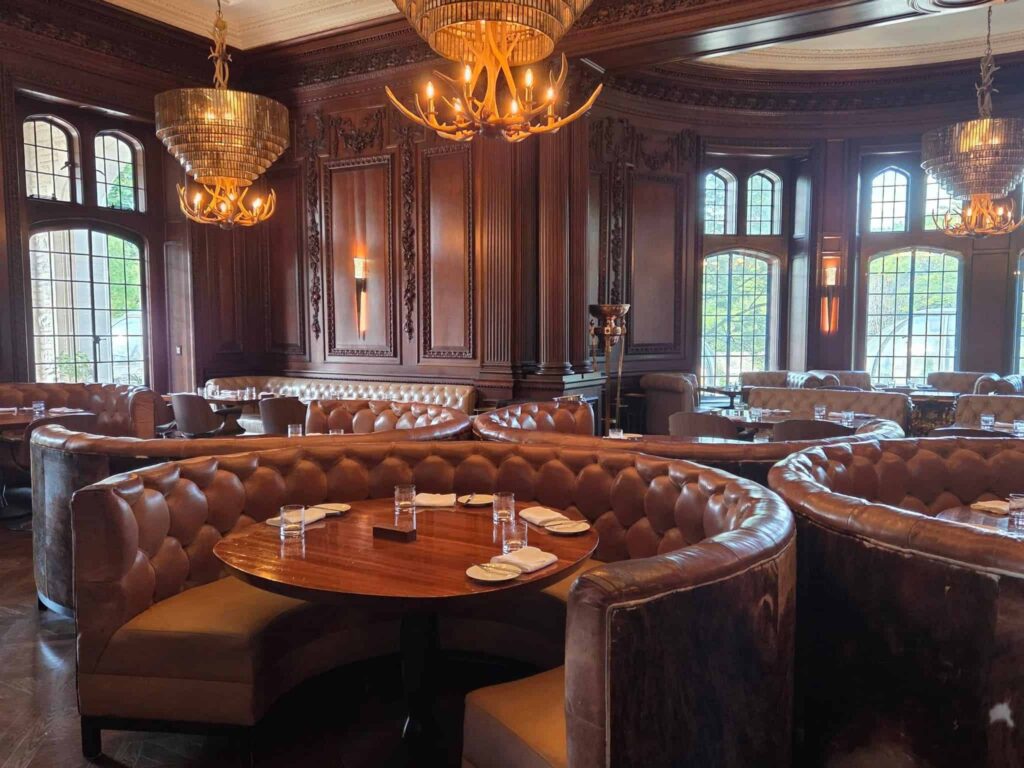 BlueBlood Steakhouse is an upscale diningroom in Casa Loma adourned with leather seating and mahogony walls and elegant chandeliers