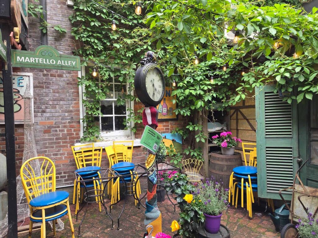 Enjoying the vibrant colours and the artwork while exploring Martello Alley in Kingston, a true Ontario hidden gem