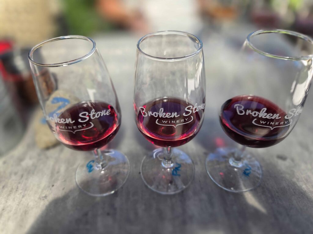 Enjoying a tasting flight of red wine when visiting Broken Stoney Winery.  They also have amazing wood-fired pizza