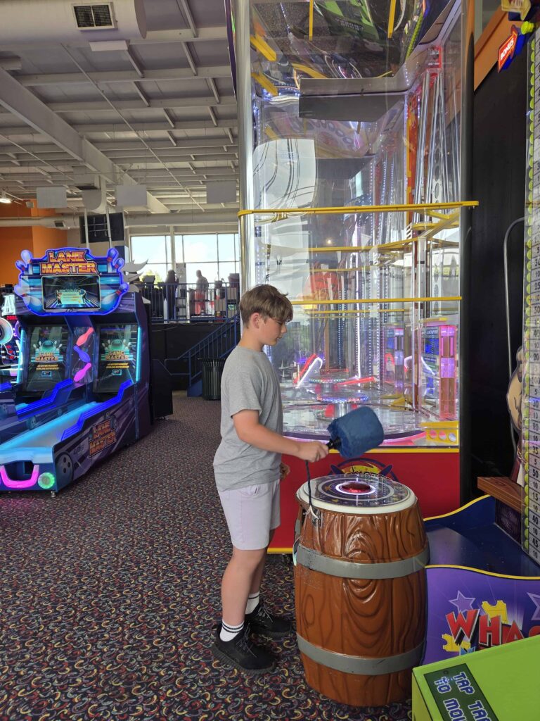 a teenage boy having fun at the arcades at Bingemans in Kitchener